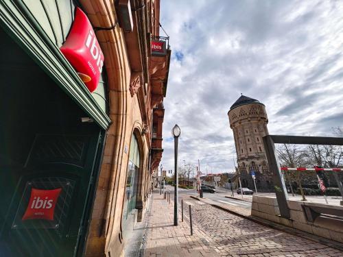 a building on a street with a clock tower at ibis Metz Centre Gare in Metz