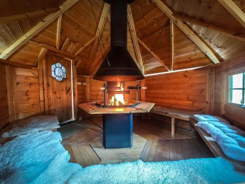 a room with a fireplace in a wooden cabin at VILA v ZAHRADÁCH in Uherské Hradiště