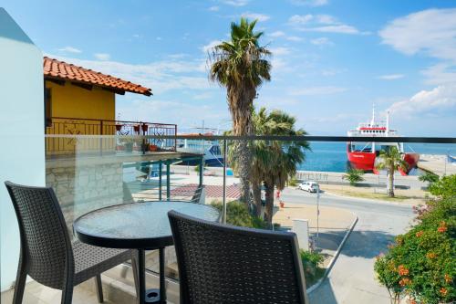 a balcony with a table and chairs and a view of the ocean at Hotel Medusa in Skala Prinou
