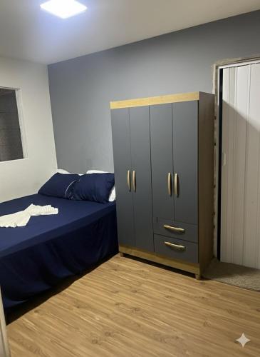 a bedroom with a bed and a large cabinet at Casa Maceió The perfect place in Maceió
