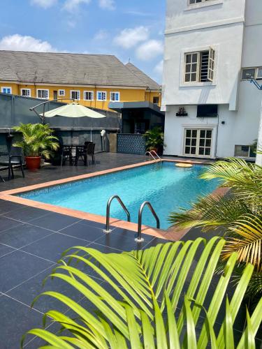a swimming pool in front of a building at Bridgewaters Hotel in Abuja