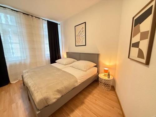 a bedroom with a bed in a room with a window at Stage One City in Andernach