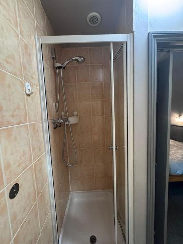 a shower with a glass door in a bathroom at Mallow View Hotel in Cleethorpes