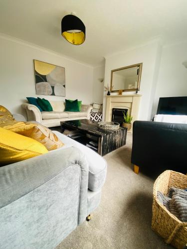 a living room with a couch and a table at 3-Bed Retreat Perfect Contractors & Leisure Stays Onsite Parking in Messingham