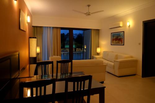 a living room with a couch and a table at Riviera Hermitage in Arpora