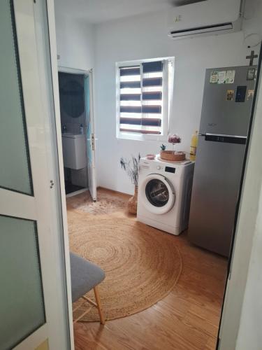 a kitchen with a washing machine and a refrigerator at Casa La Bunicu - Curte privata & liniste in Techirghiol