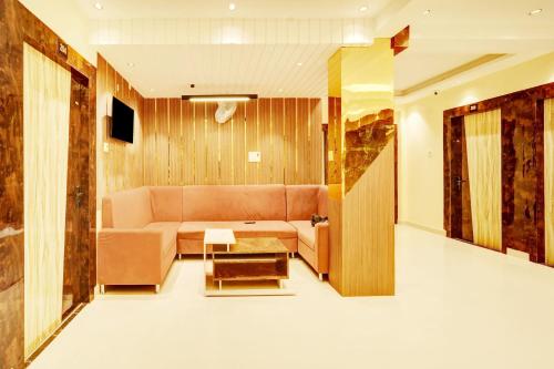 a living room with a couch and a table at HOTEL O DIVIRA INN in Dhanbād