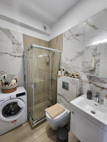 a bathroom with a shower and a toilet and a sink at Sol Greco Apartment in Skala Rachoniou