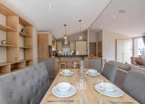 a dining room and kitchen with a table and chairs at Lower Hyde in Shanklin