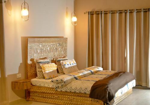 a bedroom with a bed with pillows on it at Lofted Peaks in Pālampur