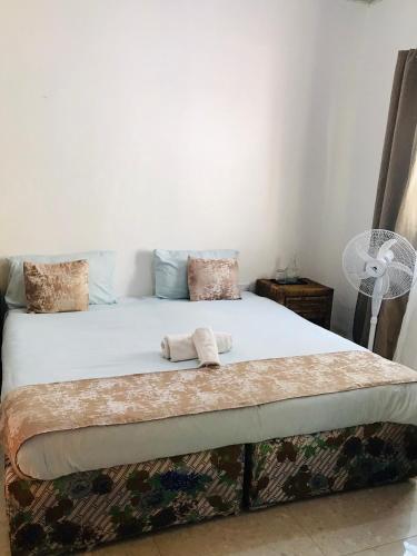 a bed with two towels on it in a room at Queen Room self contained in Lusaka