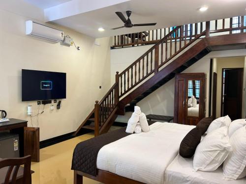 a bedroom with a large bed and a staircase at Hotel Grand Palais in Bangalore