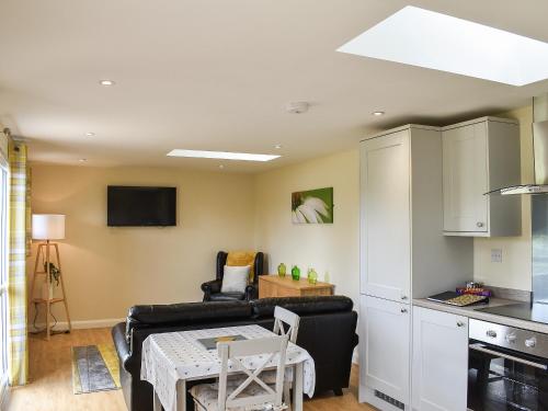a living room with a couch and a table at Sherwood Forest Lodge 2 in Clipstone