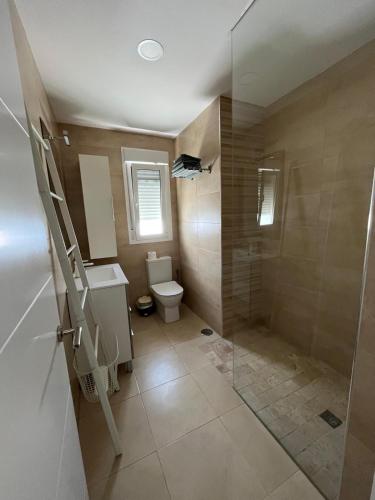 a bathroom with a toilet and a walk in shower at Casa Martina in Cádiz