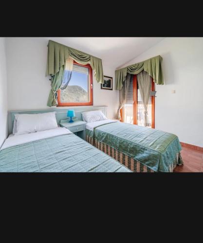 a bedroom with two beds and a window at Apartments Radević in Budva
