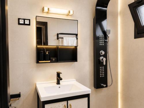 a bathroom with a sink and a mirror at Massa Residence Meublé Yaounde in Yaoundé