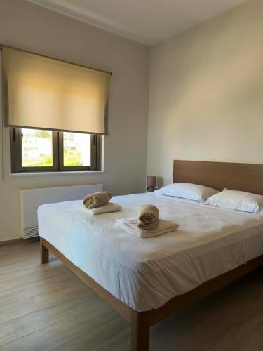a bedroom with a bed with two hats on it at Four Seasons Homes in Stalos