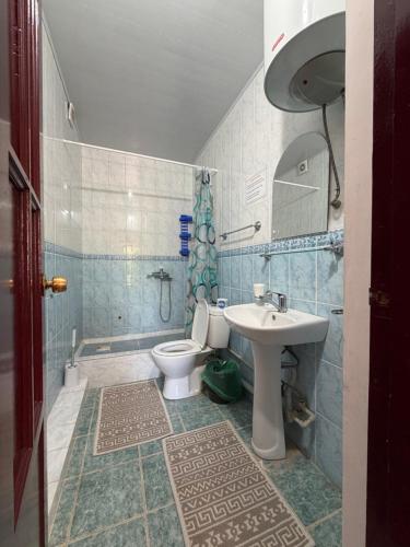a bathroom with a toilet and a sink at Алтын Мезгил in Korumdy