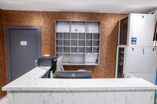 a kitchen with a white counter and a refrigerator at Casa sul Mare Luxury Sea View Apartments in Neum