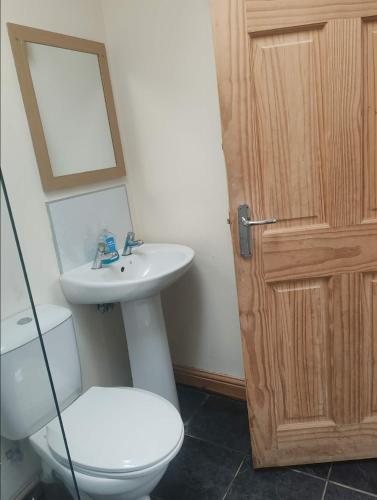 a bathroom with a toilet and a sink and a mirror at Broomfields Glamping Pods in Whitby