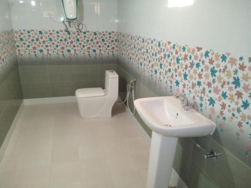 a bathroom with a toilet and a sink at Musafir Desert Camp Jaisalmer in Jaisalmer