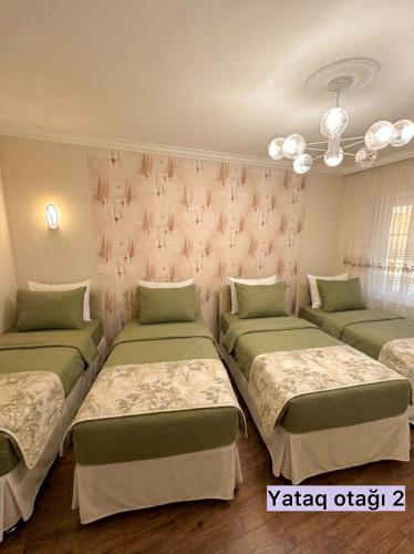 a room with three beds and a wall at Sheki Center Home in Sheki