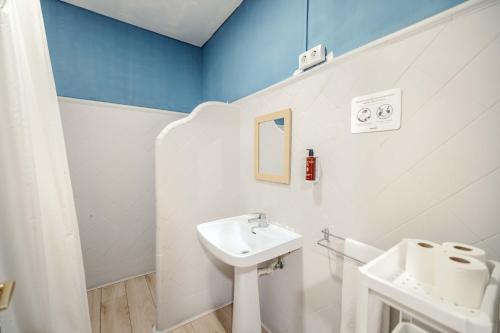 a white bathroom with a sink and a mirror at Hotel Boutique La Brisa in Vilanova i la Geltrú