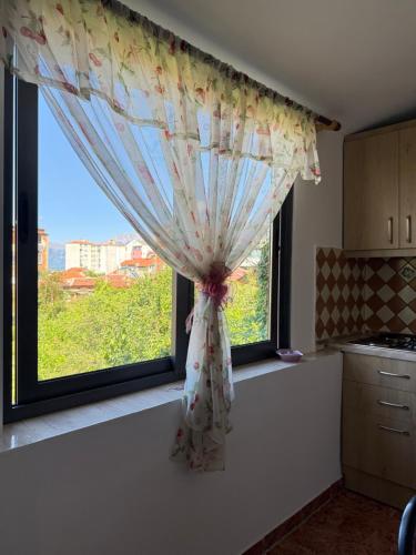 a window in a kitchen with a curtain on it at JEA House in Pogradec
