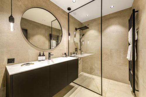 a bathroom with a sink and a mirror at Residenz Boutique Suites in Bad Gastein