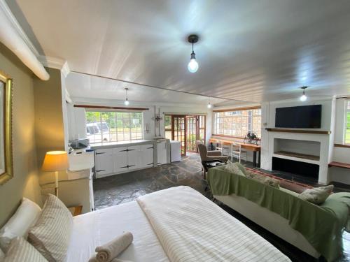 a living room with two beds and a kitchen at Guesthouse 1921 in Hartbeespoort