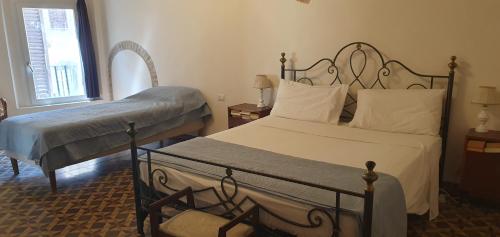 a bedroom with two beds and a chair in it at Sulla via Francigena in Fucecchio