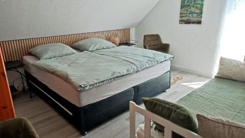 a bedroom with a bed and a chair at Bergblick2 in Zell an der Mosel