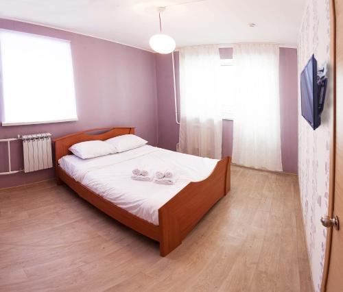 a bedroom with a bed with two glasses on it at 2k Apartment near Ashan in Tyumen
