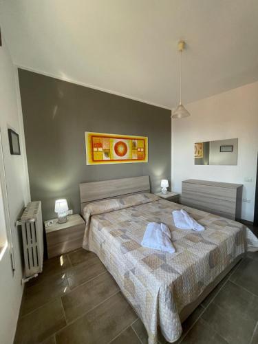 a bedroom with a large bed with two pillows on it at La Quiete dei Tacchi Ulassai in Ulassai