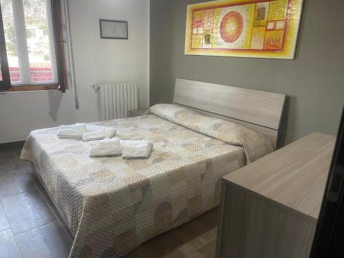a bedroom with a bed with towels on it at La Quiete dei Tacchi Ulassai in Ulassai
