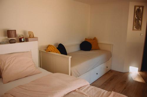 a small bedroom with two beds in it at Statek ráj Netvořice, Tiny house and Farm Experience in Netvořice