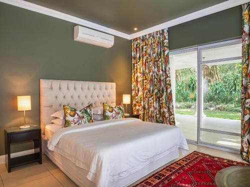 a bedroom with a large bed and a window at Palmtree Luxury Villa Eden Rock Estate, Pennington in Pennington