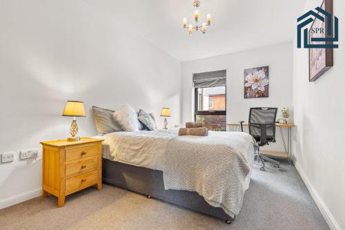 a bedroom with a bed and a dresser and a window at Reading City Getaway Stylish Flat, Sleeps 2 in Reading