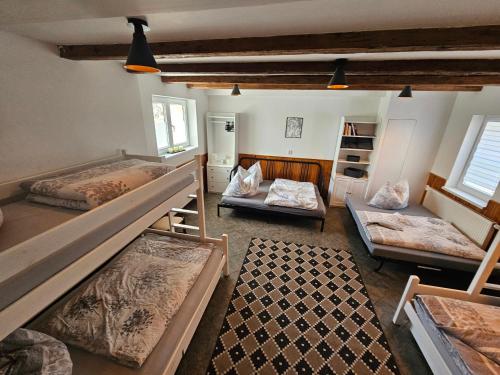 a bedroom with three bunk beds in a room at Apartmány Moravský Kras Vavřinec in Vavřinec
