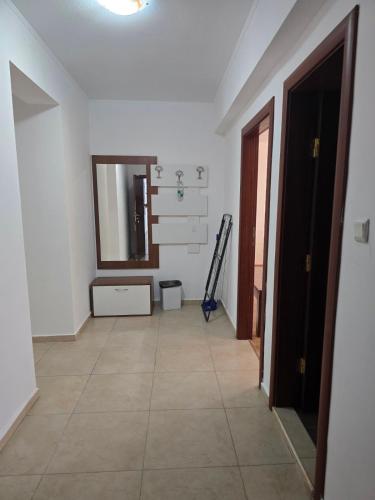 a hallway with a mirror and a tile floor at Yassen Holiday Village in Sunny Beach