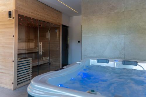 a large blue tub in a room at Villa Novara Holiday Home in Lužan Biškupečki