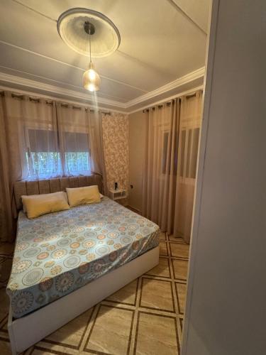 a bedroom with a bed and a chandelier at villa victoria in Tétouan