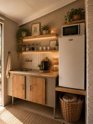 a kitchen with a sink and a refrigerator at De Haven Oost in Rayton