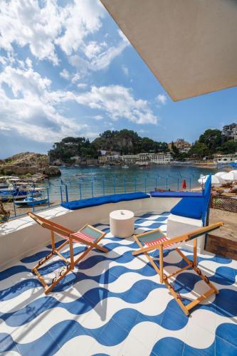 a deck with chairs and a view of the water at La Prua in Taormina