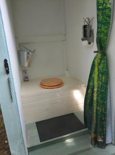 a small bathroom with a toilet with a wooden seat at Rowan retreat,Renwick, Penrith,CA10 1LA in Penrith