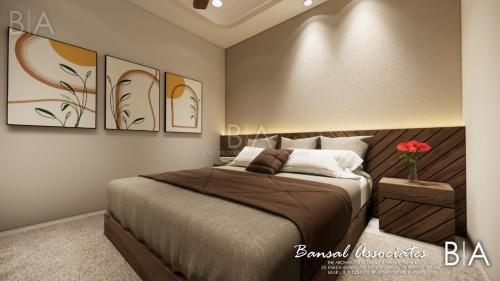 a bedroom with a bed and some paintings on the wall at Hotel 9Eleven & Cafe in Barnāla