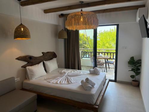 a bedroom with a bed with towels on it at Hotel marmaras in Neos Marmaras