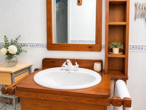a bathroom with a sink and a mirror at El Cajigar Ordesa Aínsa in Laspuña