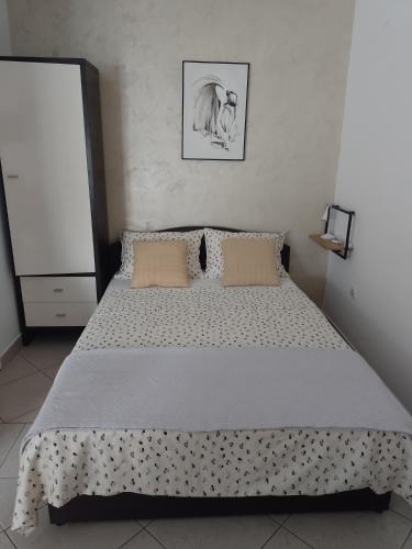 a bedroom with a large bed with polka dot sheets at Apartman Cvitan in Zaton