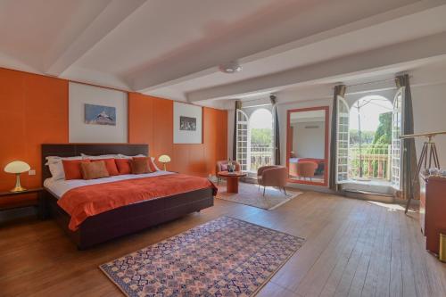 a bedroom with orange walls and a bed with a rug at Château de Taradel in Taradeau